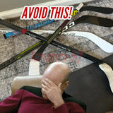 Clutter of knee hockey sticks on the floor with a frustrated person, emphasizing the need for a mini stick holder to organize.