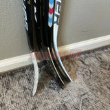 Wall-mounted mini stick holder keeping knee hockey sticks organized and accessible in a home setting.
