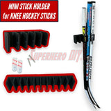 Wall-mounted mini stick holder for knee hockey sticks with slots for organizing and displaying multiple sticks. Includes screws for installation.