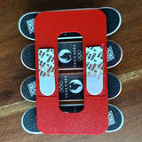 Magnetic Tech Deck wall mount displaying fingerboards with Paris 2024 theme, showcasing artwork and mini skateboard arrangement.