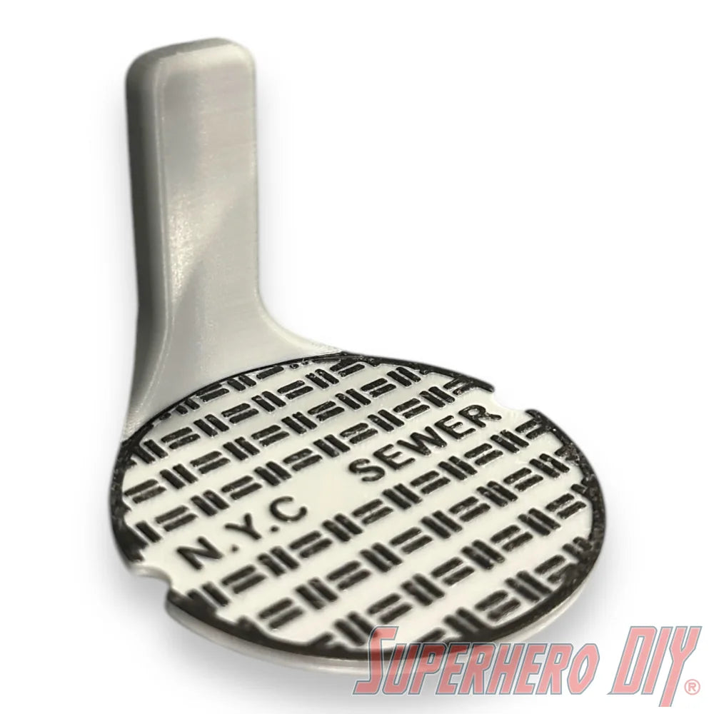 Floating shelf designed to display TMNT action figures and collectibles, styled like a sewer manhole cover for themed wall display