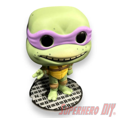 Floating shelf designed to display TMNT action figures and collectibles, styled like a sewer manhole cover for themed wall display