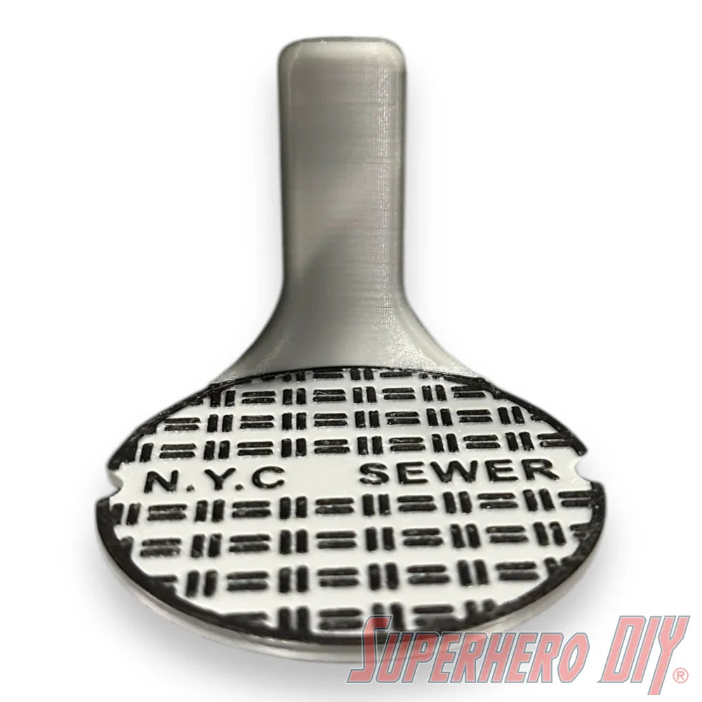 Floating shelf designed to display TMNT action figures and collectibles, styled like a sewer manhole cover for themed wall display