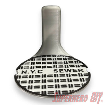 Floating shelf designed to display TMNT action figures and collectibles, styled like a sewer manhole cover for themed wall display