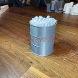 3D-printed mini oil drum desk organizer filled with q-tips, shown on a wooden surface.