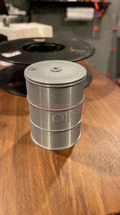 Mini oil drum desk organizer for holding small items, candy, or as a gag gift, 3D-printed plastic design on a wooden table.