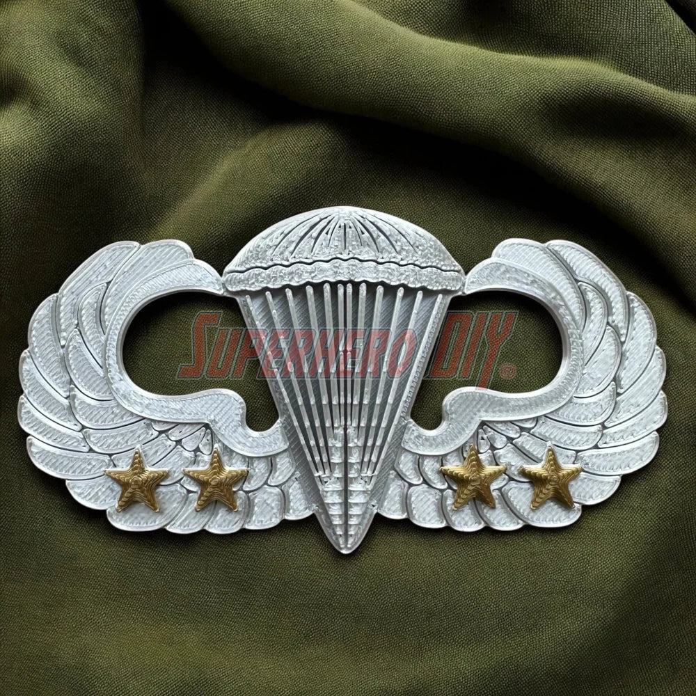 Jump Wings replica with parachute and stars, symbolizing Army Airborne achievements.
