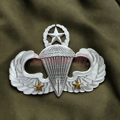 Jump Wings Parachutist Badge on military green fabric background