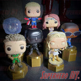 Display riser stands for Funko Pop featuring various collectible figures on gold pedestal bases.