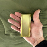 Hand holding a gold 2nd Lieutenant O-1 Ensign rank insignia replica, showcasing its glossy, detailed finish.