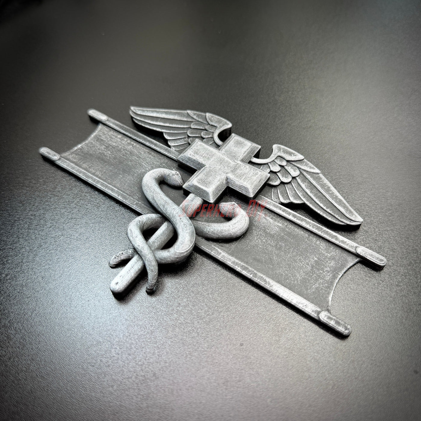 Army medical badge display showing a Combat Medical Badge with caduceus and Geneva Convention cross detail.
