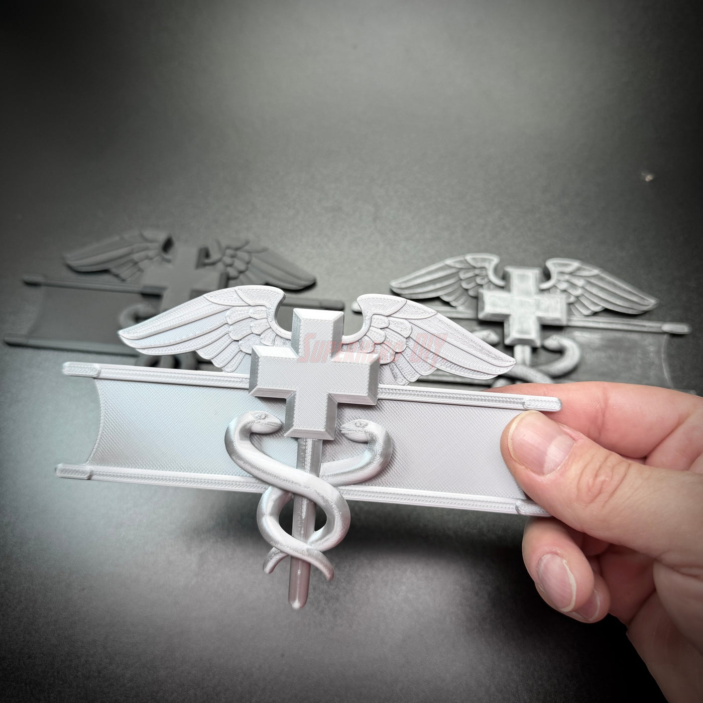 army medical badge display featuring caduceus and Geneva Convention cross in multiple colors