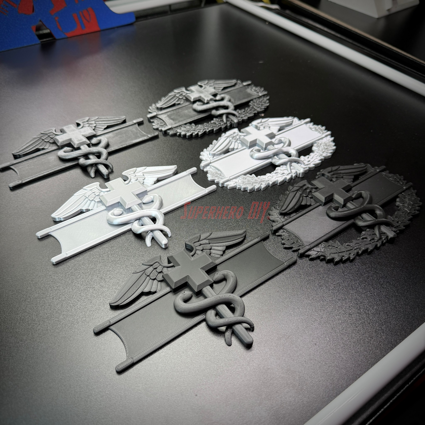 Image of army medical badge display showcasing EFMB, CMB, MCMB in various colors and designs.