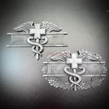 Army medical badge display featuring EFMB and CMB designs with caduceus and Geneva Cross.