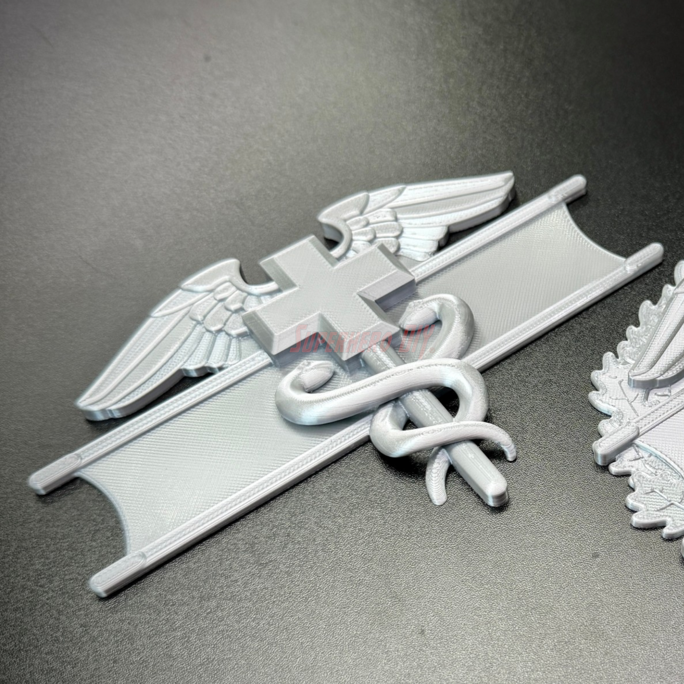 Army medical badge display featuring the caduceus and cross of Geneva Convention.