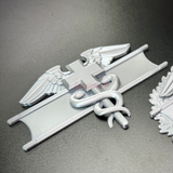 Army medical badge display featuring the caduceus and cross of Geneva Convention.