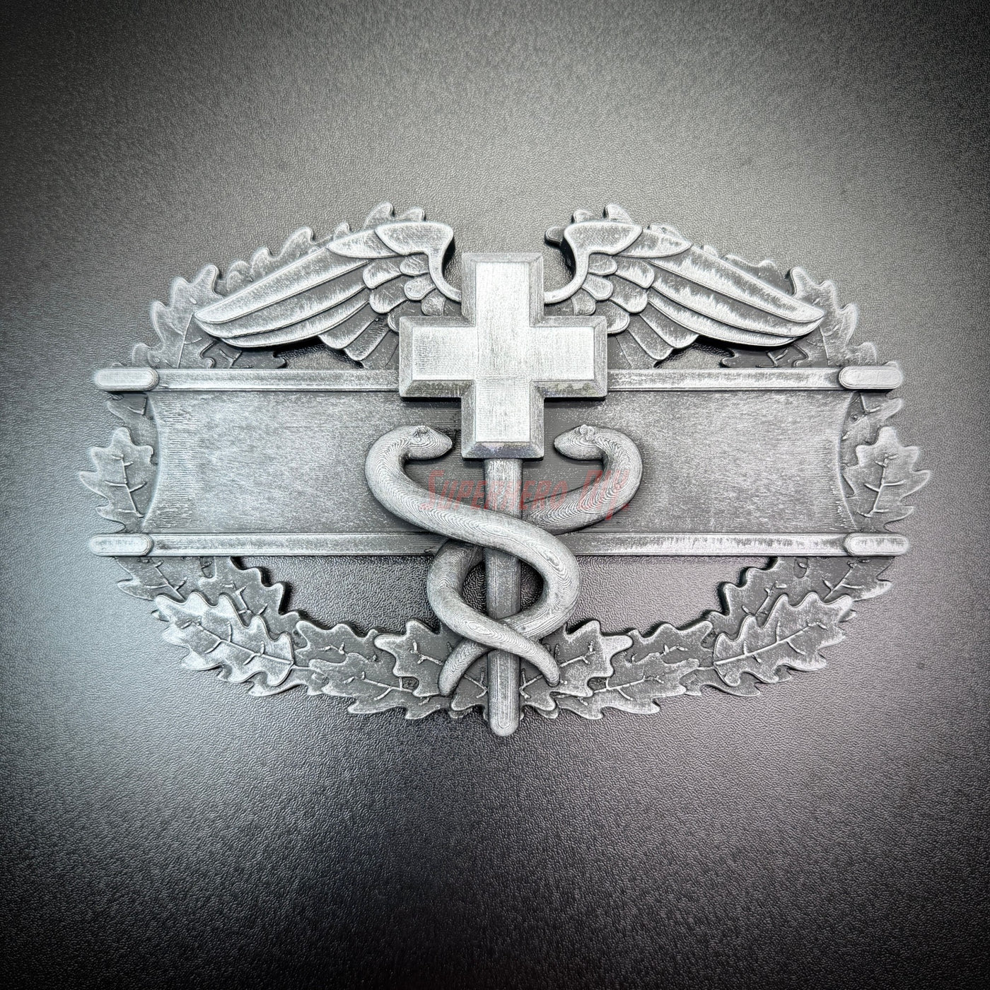 Army medical badge display insignia featuring a caduceus and Geneva Convention cross.