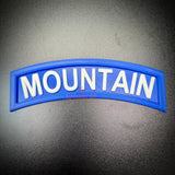 3D mountain tab wall display in blue with raised white lettering