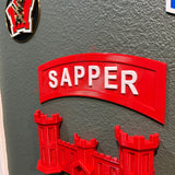 3D sapper tab display piece in red mounted on a wall, showcasing combat engineer insignia.