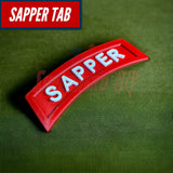 3D sapper tab displayed on a green background, showcasing its red color and white lettering.