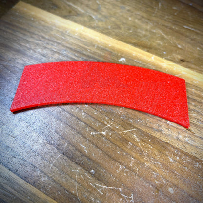 3D sapper tab in vibrant red color displayed on wooden surface.