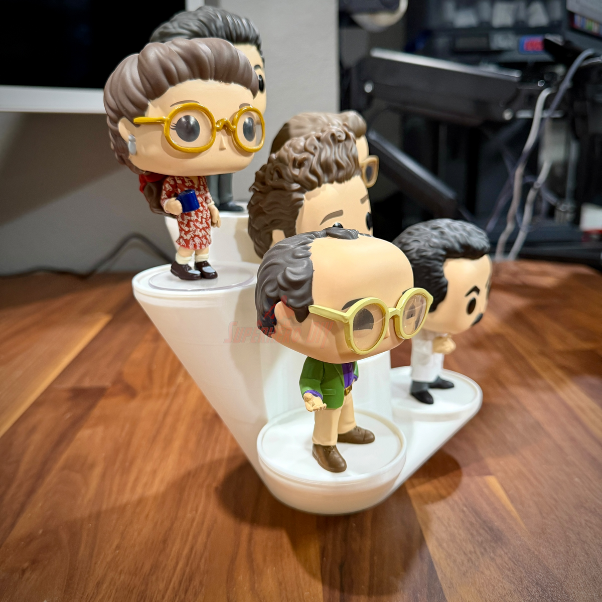 Funko Pop display riser holding a group of vinyl figures at staggered heights