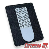 Blister pack wall hanger with Command Strip for damage-free mounting of action figures and collectibles.