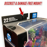 Blister pack wall hanger displaying action figure, showcasing discreet and damage-free mount with Command Strips.