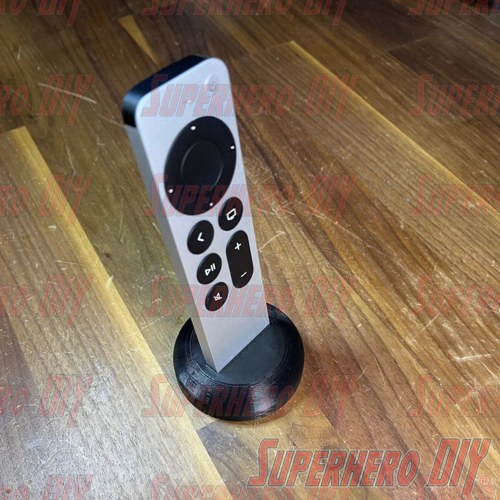 Apple TV Remote Stand holding Apple TV Siri Remote upright on wooden surface