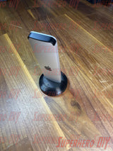 Apple TV Remote Stand on wooden table, holding Siri Remote upright for easy access and organization.