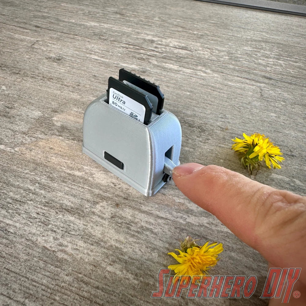 Mini toaster-shaped SD card holder that stores 2 memory cards and doubles as a fun desktop fidget