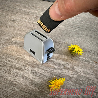 Mini toaster-shaped SD card holder that stores 2 memory cards and doubles as a fun desktop fidget