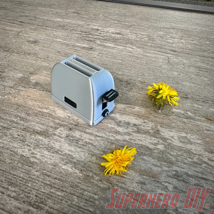 Mini toaster-shaped SD card holder that stores 2 memory cards and doubles as a fun desktop fidget