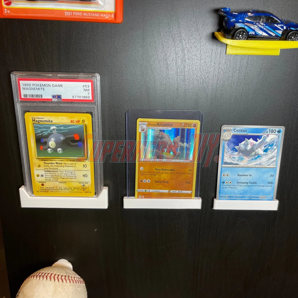 Trading card wall mounts displaying graded Pokemon cards on a wall, featuring a neat and space-saving design for collectors.