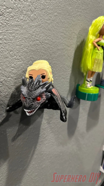 Black dragon wall mount holding Daenerys Targaryen Funko Pop figure against gray wall. - SuperheroDIY