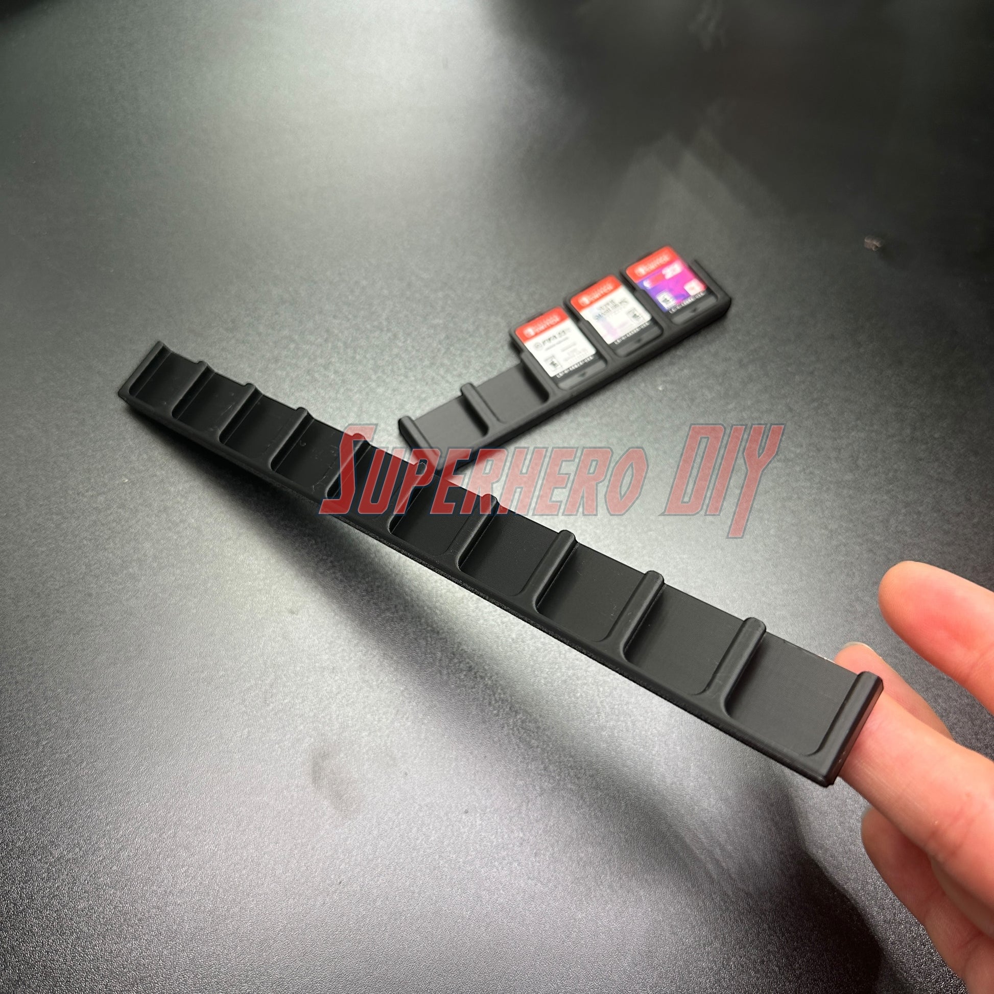 Game Cartridge Holder for Nintendo Switch – 5 or 10 Slot Display Rack showcasing slots and game cartridges on a desk.