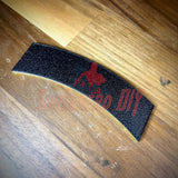 3D airborne tab displayed on a wooden surface, featuring a solid black design with yellow accents.