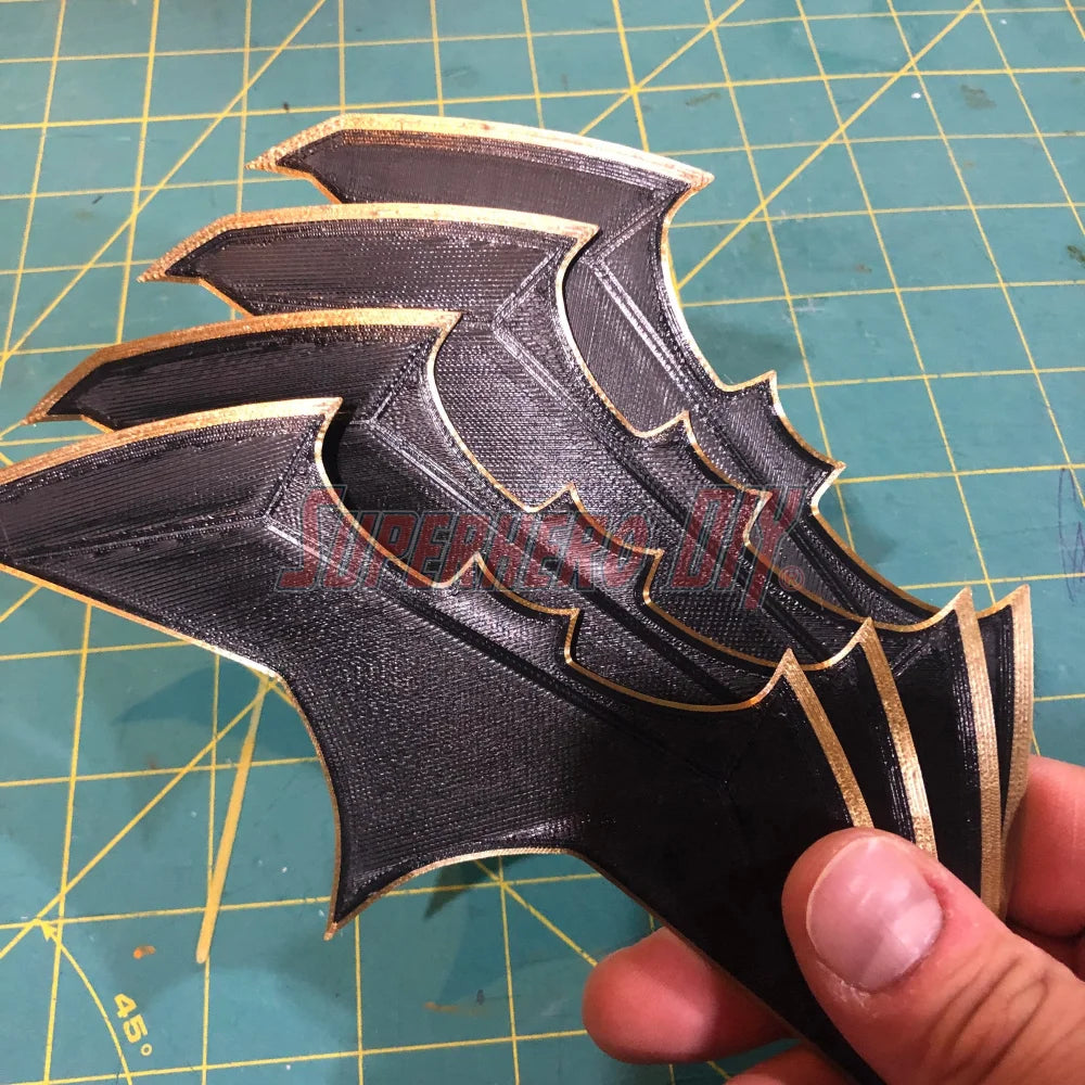 Set of BvS JL batarang prop in black with gold trim, ideal for cosplay or costumes, made from eco-friendly PLA plastic.