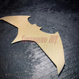 Gold BvS JL batarang prop on a dark surface, showcasing its detailed 3D-printed design for cosplay or decoration.