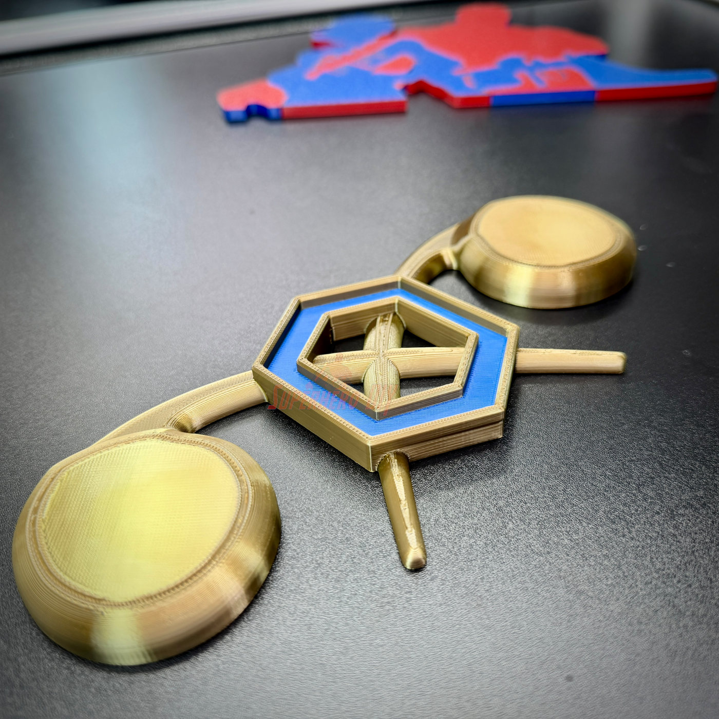 Chemical Corps insignia displayed on a dark surface, featuring a cobalt blue benzene ring and crossed gold retorts.