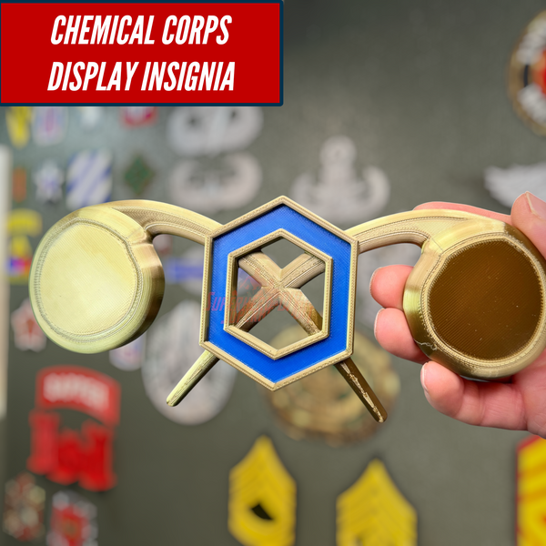 Hand holding Chemical Corps insignia display with cobalt blue and gold details, perfect for wall decor.