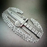 combat action badge display featuring a detailed replica with bayonet and oak wreath design