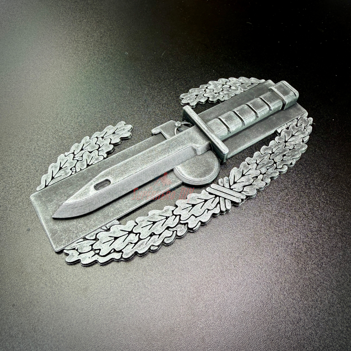Combat Action Badge Display Insignia featuring a bayonet and oak wreath, ideal for wall or desk display.
