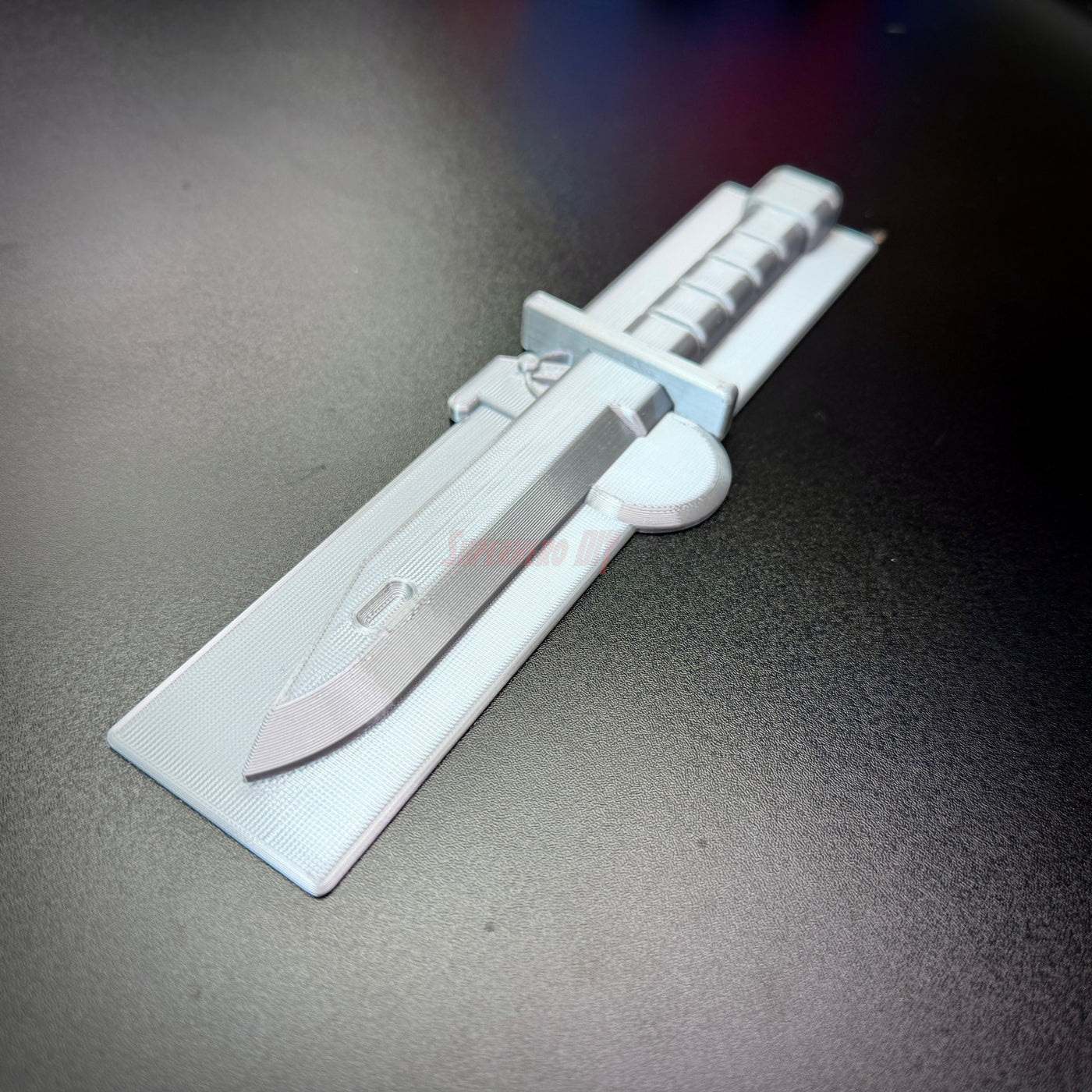 Expert Soldier Badge display insignia featuring M9 bayonet design in silver.