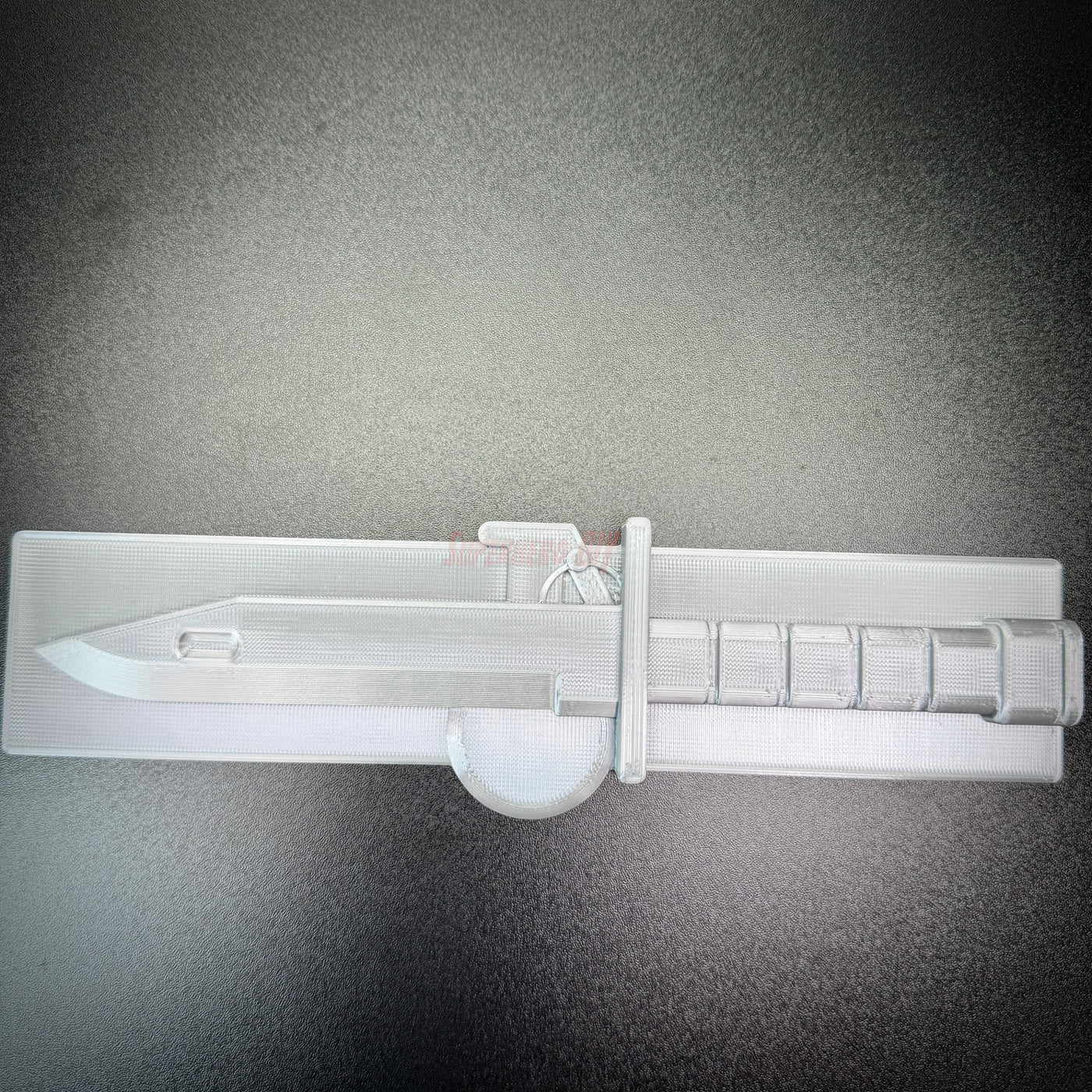 Expert Soldier Badge display insignia with an M9 bayonet design on a smooth background.