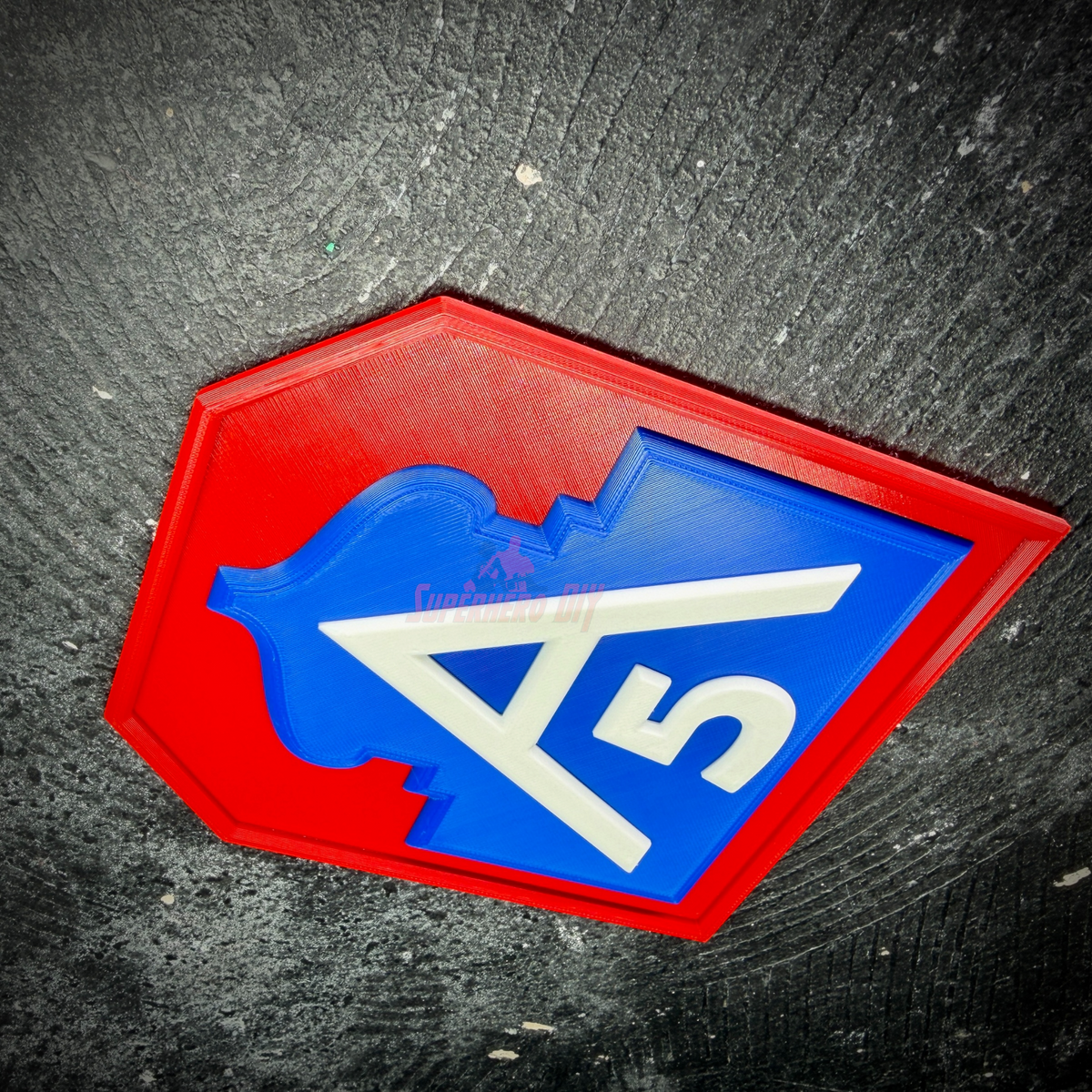 Steep angle of the Fifth Army insignia display with the raised white A and 5 standing above the blue field