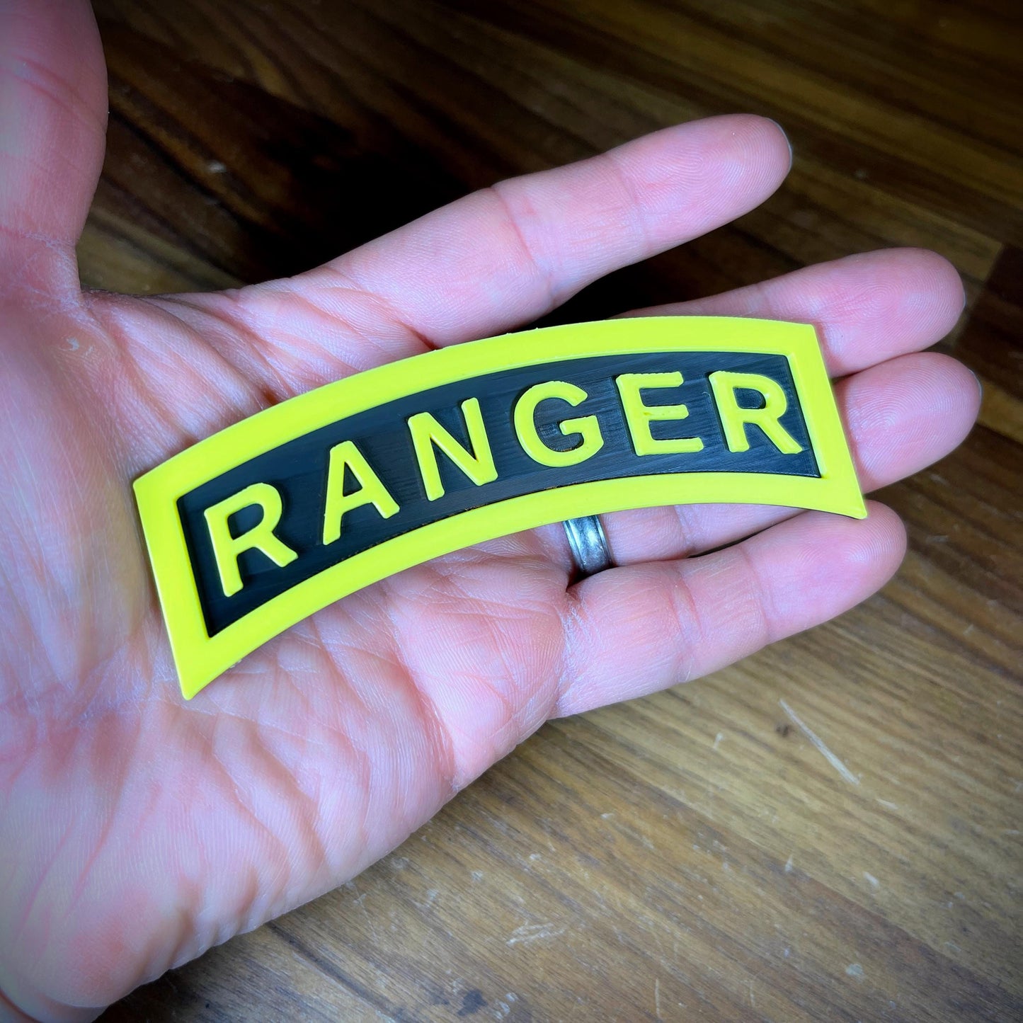 3D Army Ranger tab displayed in hand, featuring the iconic yellow and black design.