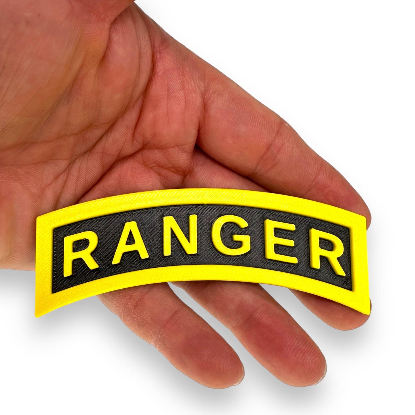 3D Army Ranger tab replica displayed in hand, showcasing the yellow-on-black design for military collections.