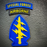 Special Forces display insignia featuring arrowhead and Airborne tab on a textured background.
