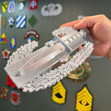 Combat Action Badge display insignia held in hand, showcasing bayonet and oak wreath design.